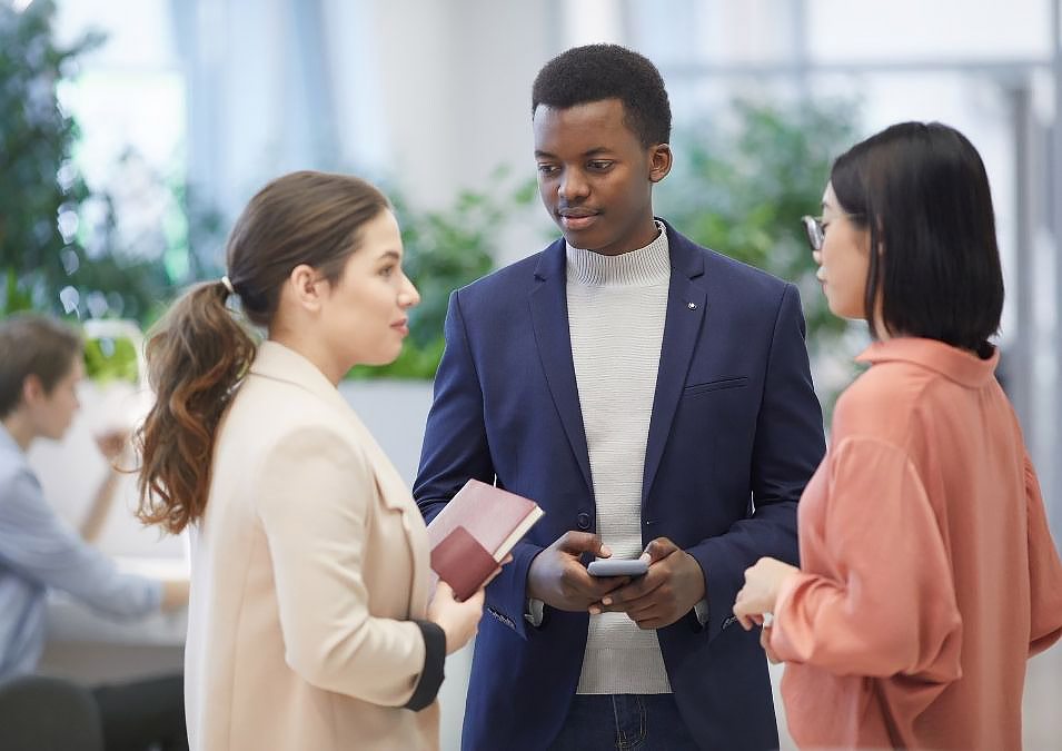 Group of young men and women conversing