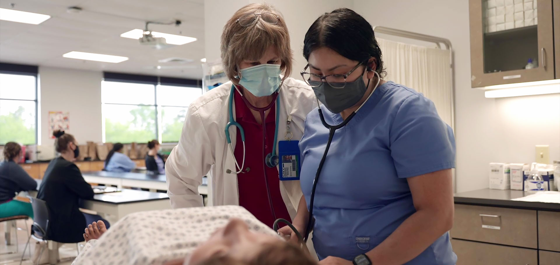 Nursing instructor works with student