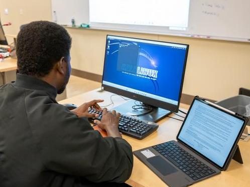 Cybersecurity student sitting at computer