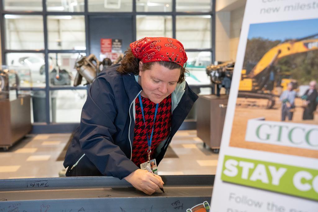 Someone signing the final GTCC Aviation Center beam