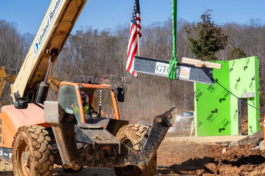Blum construction workers putting the final beam on the GTCC Aviation Center