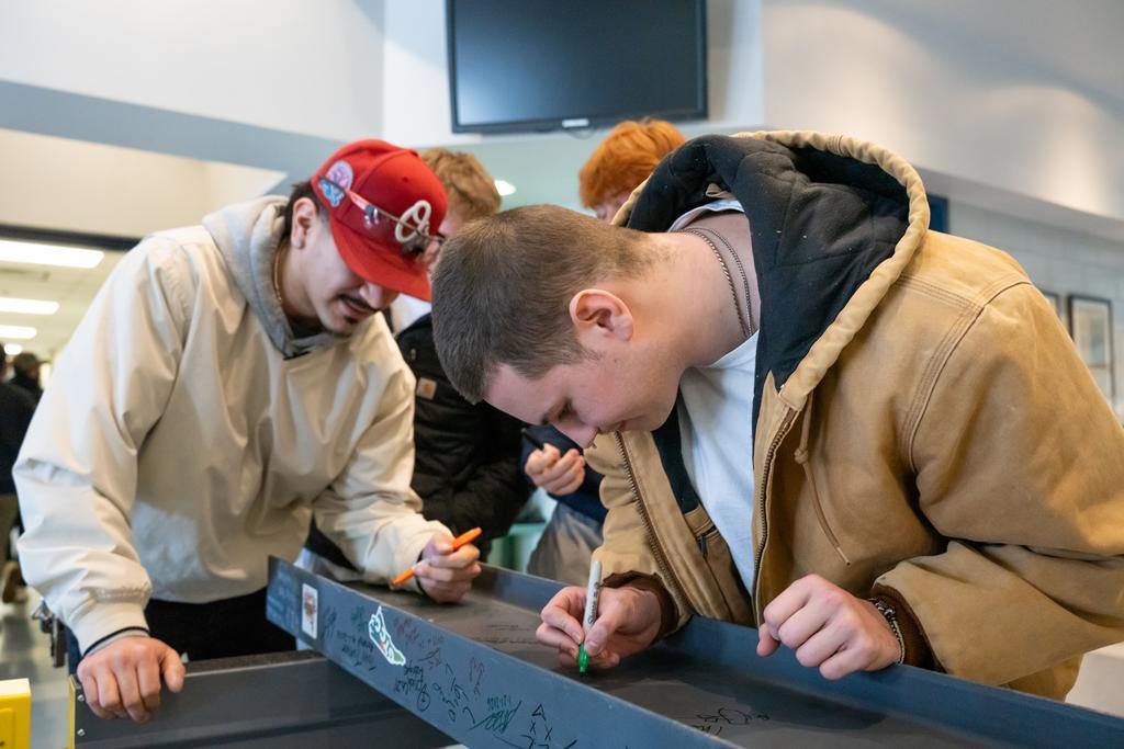 GTCC students signing the final GTCC Aviation Center beam