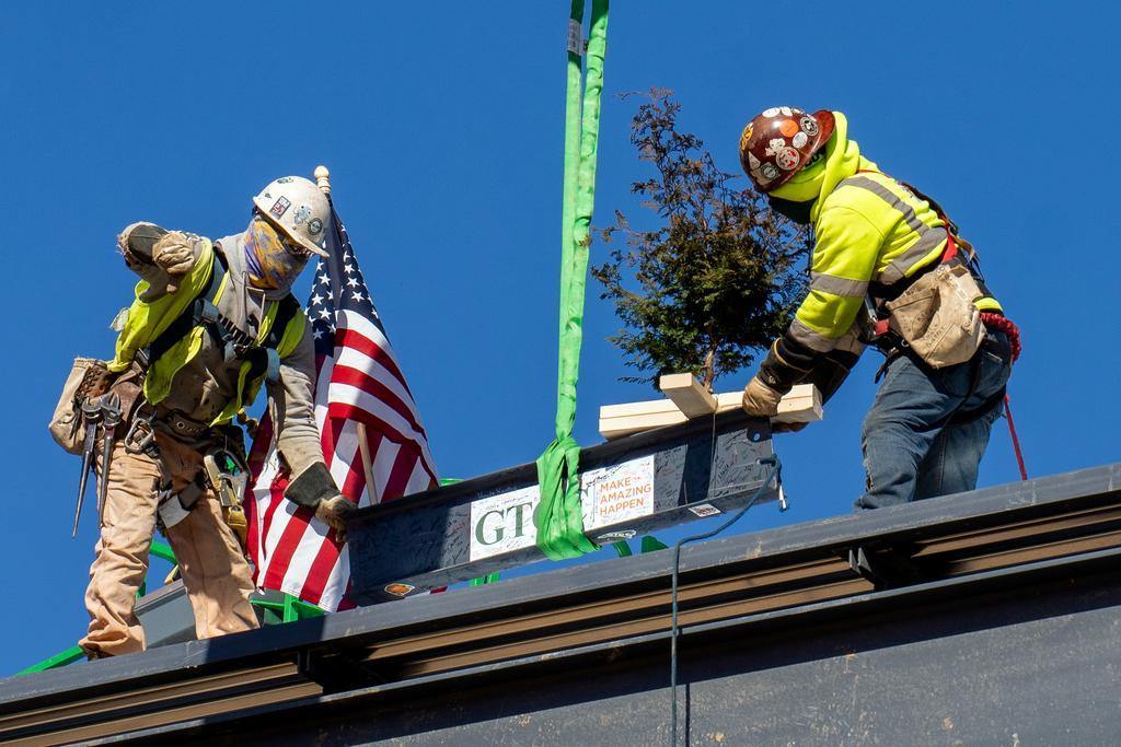 Blum construction workers putting the final beam on the GTCC Aviation Center
