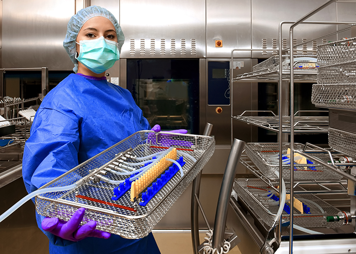 Woman with a basket of sterile medical instruments.