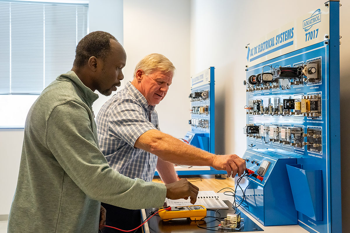Abdelazeem Ali (left) and mechatronics instructor Ralph Prouty train together.