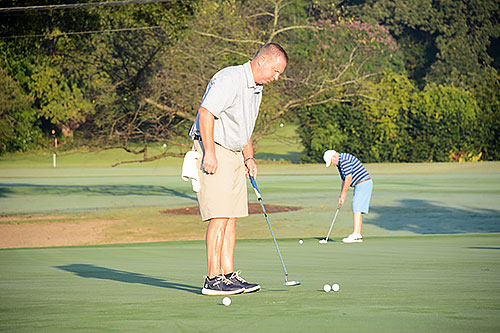 Golfers putt prior to the 2019 tournament
