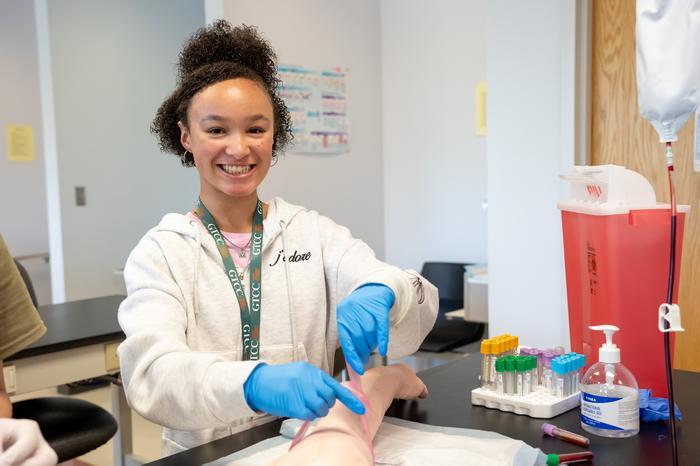 Scrub Life student handling a human dummy