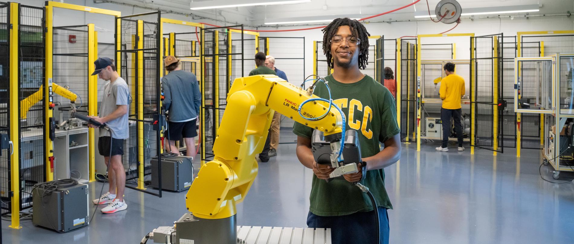 GTCC mechantronics student working controlling a robotic arm