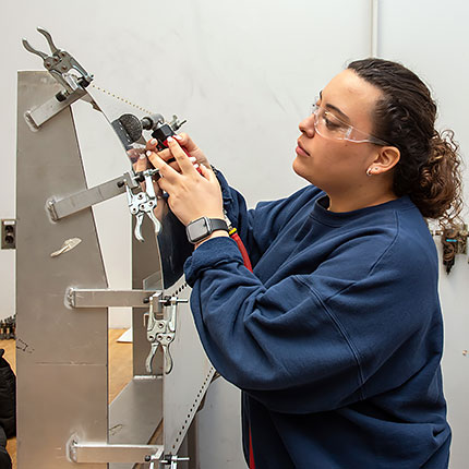 Melissa Bursus doing hands on work in Haeco structures assembly and repair class.