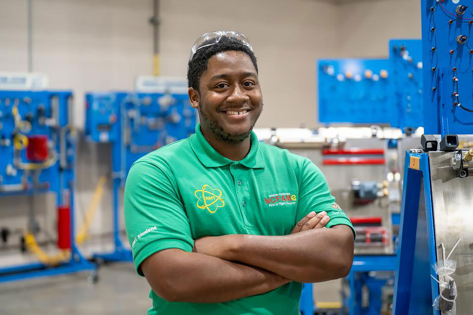 FAME student Devante Cuthberson smiles while standing in the student lab.