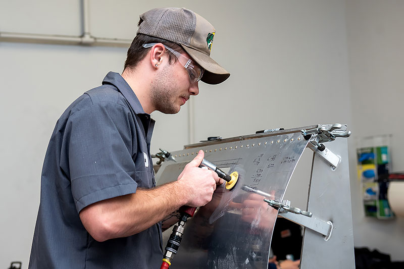 Noah Gooch works on a metal frame in Haeco Structures assembly and repair class.