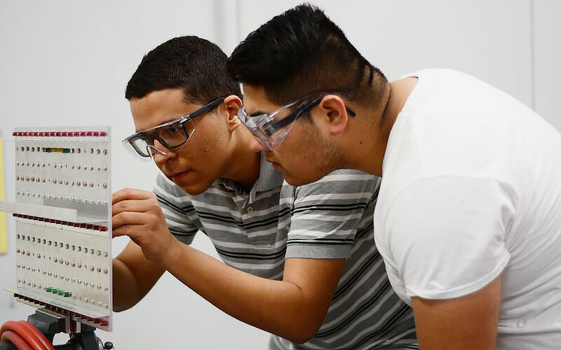 Students inspecting wing structure