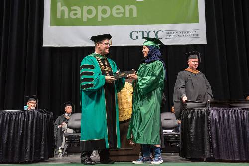 GTCC President Anthony Clarke, Ph.D. congratulating a GTCC student from the 11 a.m. commencement ceremony.