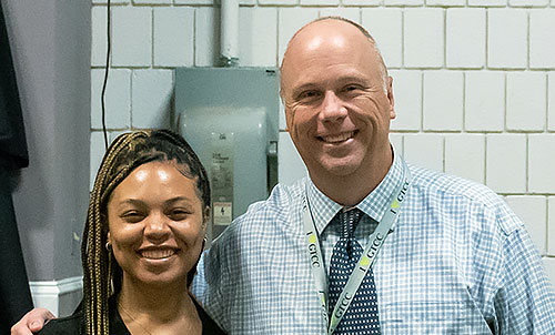 GTCC March employee of the month Shawn Dee (right) with a student during graduation. 