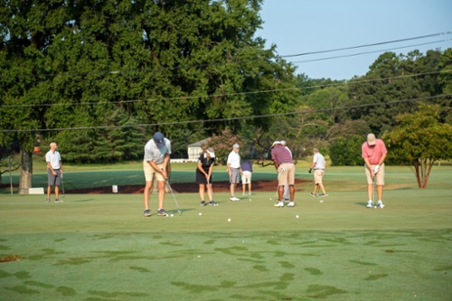 Players practice putting before the 2021 GTCC Foundation Golf Classic.