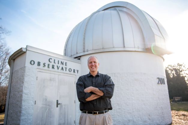 Tom English poses outside the Cline Observatory on the GTCC Jamestown campus.