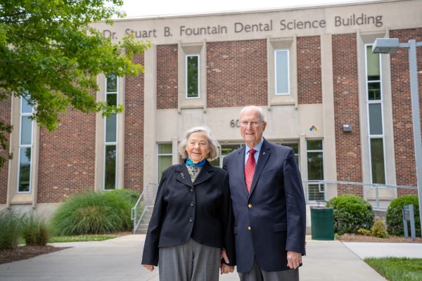 Carol Fountain and Dr. Stuart Fountain stand in front of the Dr. Stuart B. Fountain dental science building on GTCC's Jamestown Campus. The couple have been longtime supporters of the college.