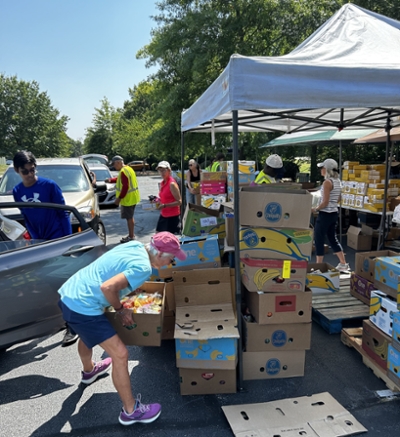 Out of the Garden Project workers assist at one of its recent Fresh Mobile Markets in the Triad. 