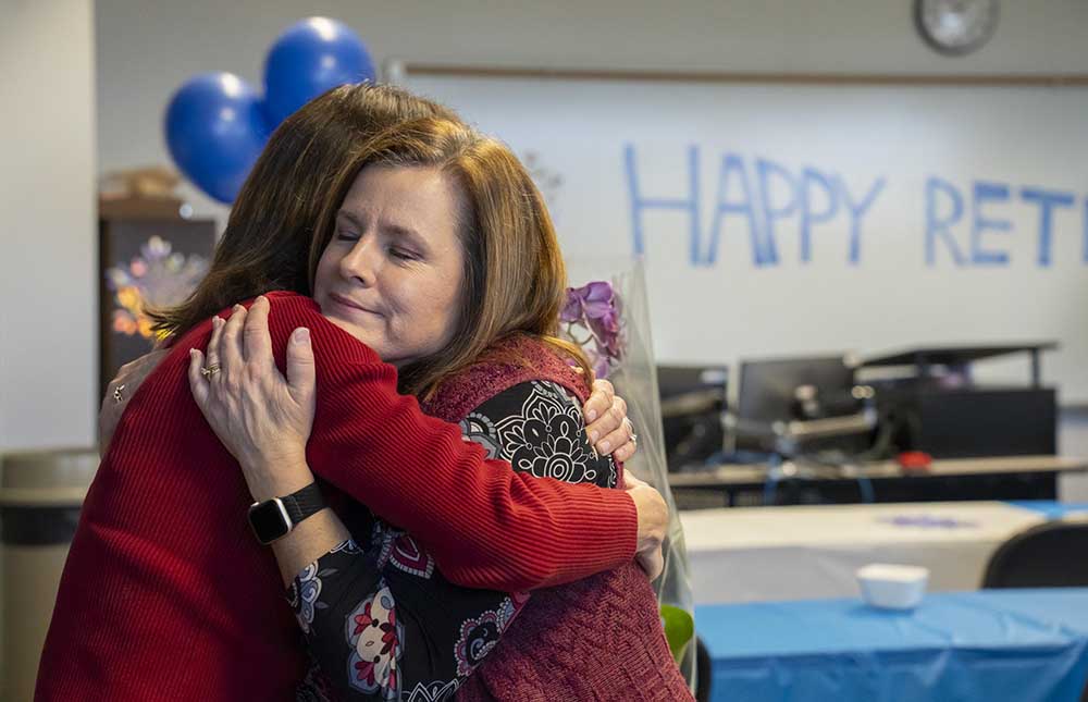 Linda Whitlow being hugged by a GTCC staff member.