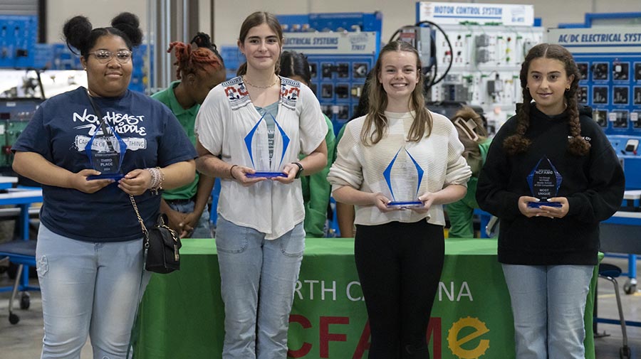 Third-place winner Quinerly Sheppard (Guilford County Schools/Northeast Middle), first-place winner Sofia Britt (Guilford County Schools/Mendenhall Middle), second-place winner Madison Hicks (Asheboro City School/Asheboro Middle), and winner for the most unique bridge design Siara Ghamrawy (Guilford County School/Brown Summit Middle).