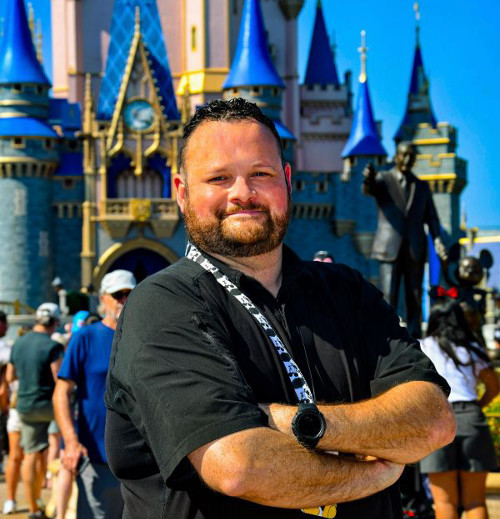 Profile of Kevin Neff with Magic Kingdom buildings in the background.