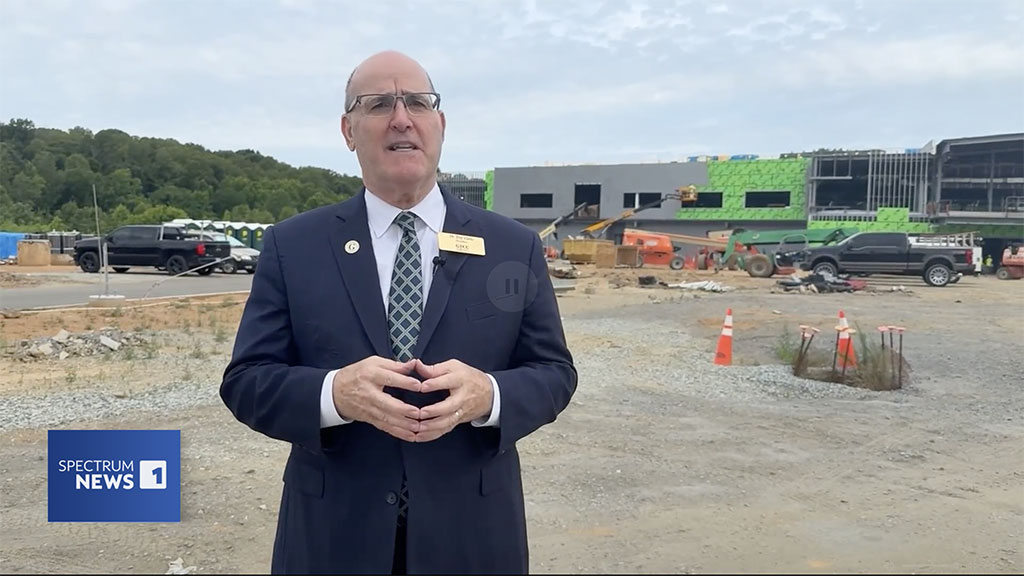 Dr. Anthony Clarke discusses GTCC / JetZero aviation parternship, standing in front of constructed GTCC Aviation Center