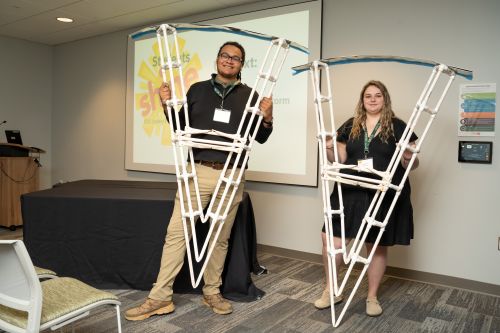 Engineering students Vincent Forkner and Jenna Moore display their working scale model of the Maeslantkering storm surge barrier in the Netherlands.