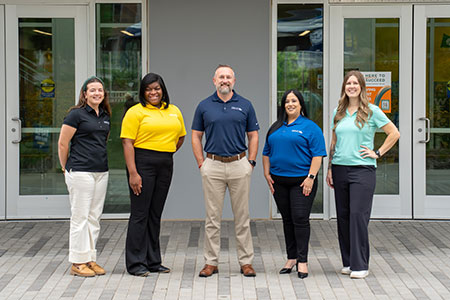 Five GTCC recruiters standing and facing the camera with a smile